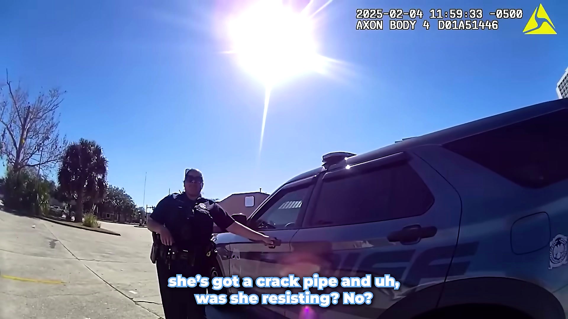 An officer speaks near a patrol vehicle while explaining the case status.
