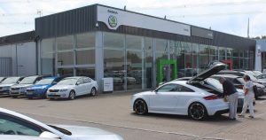 Car dealership showroom illustrating auto loan add ons checklist before signing a car loan