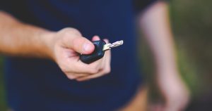 Handing over keys illustrating auto loan co signer risks checklist before signing