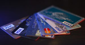 Credit cards and financial records on a table illustrating FTC credit repair scam checklist topics
