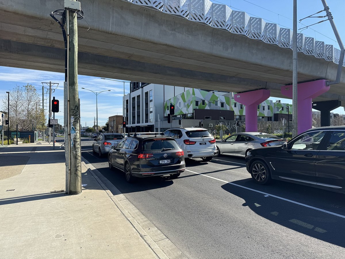Cars stopped at a signalised pedestrian crossing, an everyday road safety scene